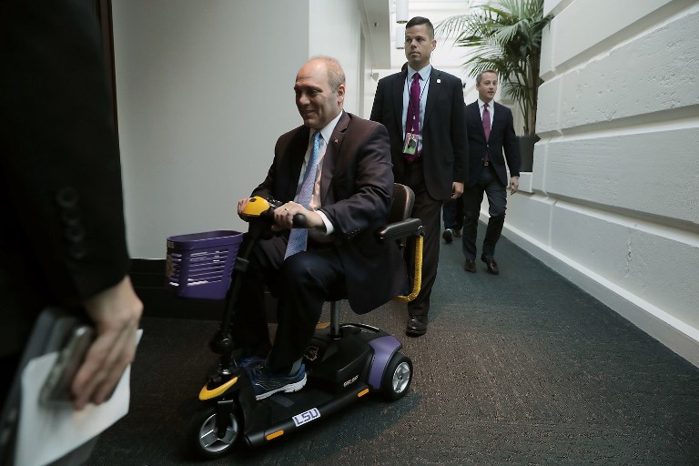 WASHINGTON, DC - OCTOBER 03: House Majority Whip Steve Scalise (R-LA) rides on a Louisiana State University-themed scooter as he arrives for the weekly House GOP conference meeting at the U.S. Capitol October 3, 2017 in Washington, DC. This was Scalise's first conference meeting since being shot during a Congressional sports practice in June.   Chip Somodevilla/Getty Images/AFP