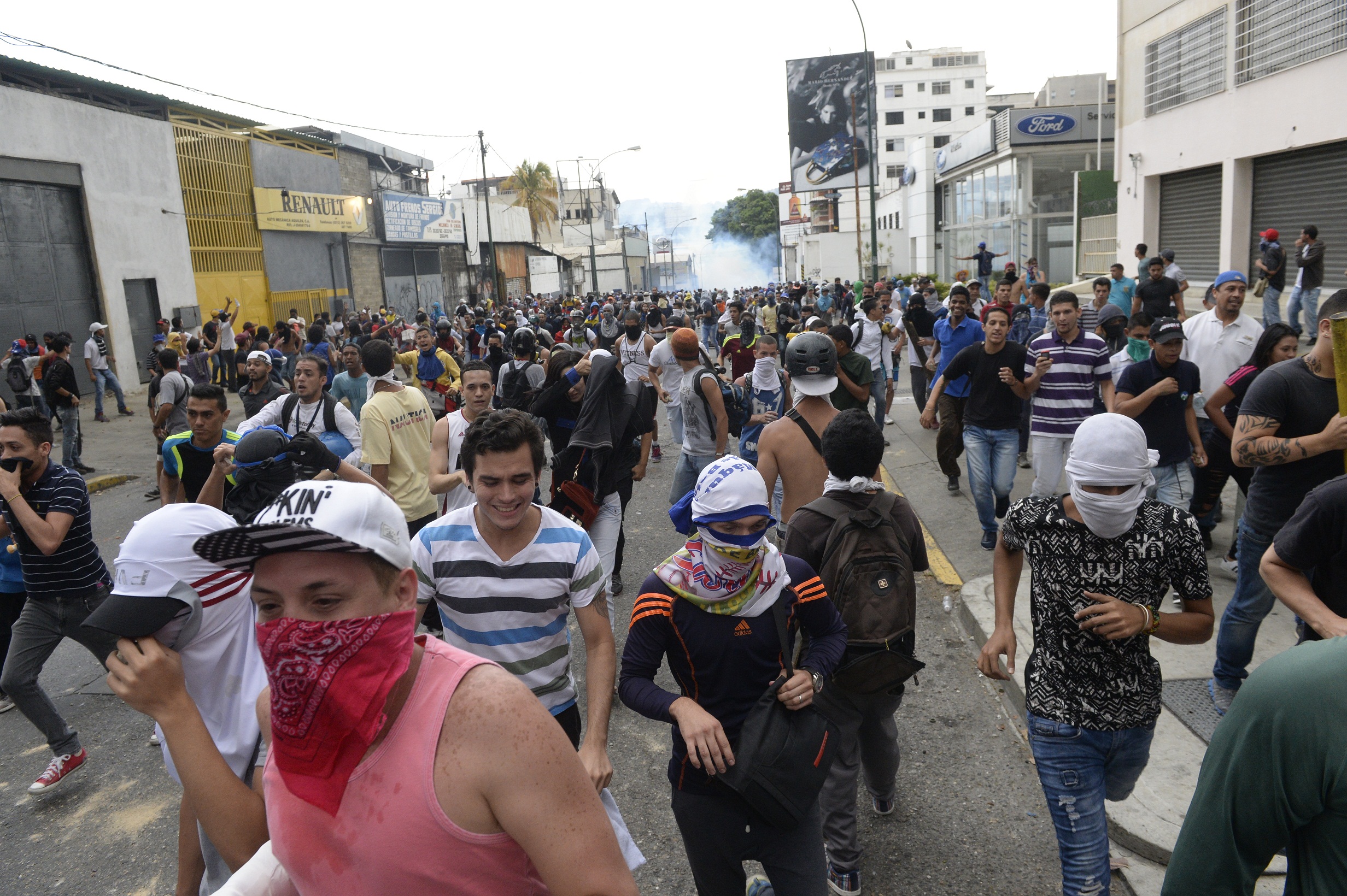 Venezuelan opposition activists clash with riot police in Caracas on April 10, 2017. Venezuela's political crisis intensified last week when the Supreme Court issued rulings curbing the powers of the opposition-controlled legislature. The court reversed the rulings days later, but the opposition intensified its protests from that moment. / AFP PHOTO / FEDERICO PARRA