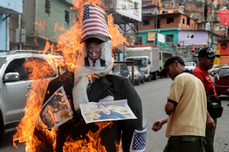 Un muñeco de Donald Trump es quemado en una barriada de la ciudad de Caracas. AFP PHOTO