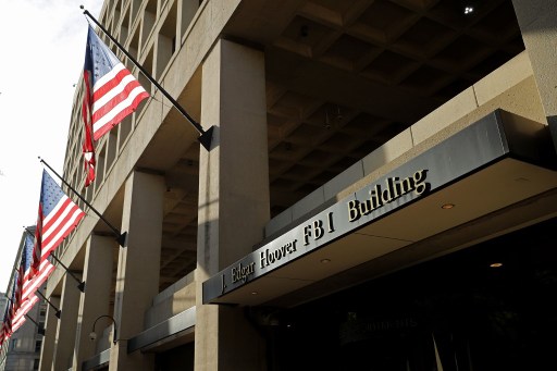 WASHINGTON, DC - MAY 09: United States flags hang in front of the Federal Bureau of Investigation Edgar J. Hoover Building May 9, 2017 in Washington, DC. On the recommendation of U.S. Attorney General Jeff Sessions, President Donald Trump fired FBI Director James Comey Tuesday. Chip Somodevilla/Getty Images/AFP