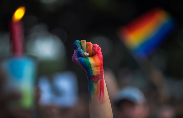 LOS ANGELES, CA - JUNE 13: A defiant fist is raised at a vigil for the worst mass shooing in United States history on June 13, 2016 in Los Angeles, United States. A gunman killed 49 people and wounded 53 others at a gay nightclub in Orlando, Florida early yesterday morning before suspect Omar Mateen also died on-scene. (Photo by David McNew/Getty Images)