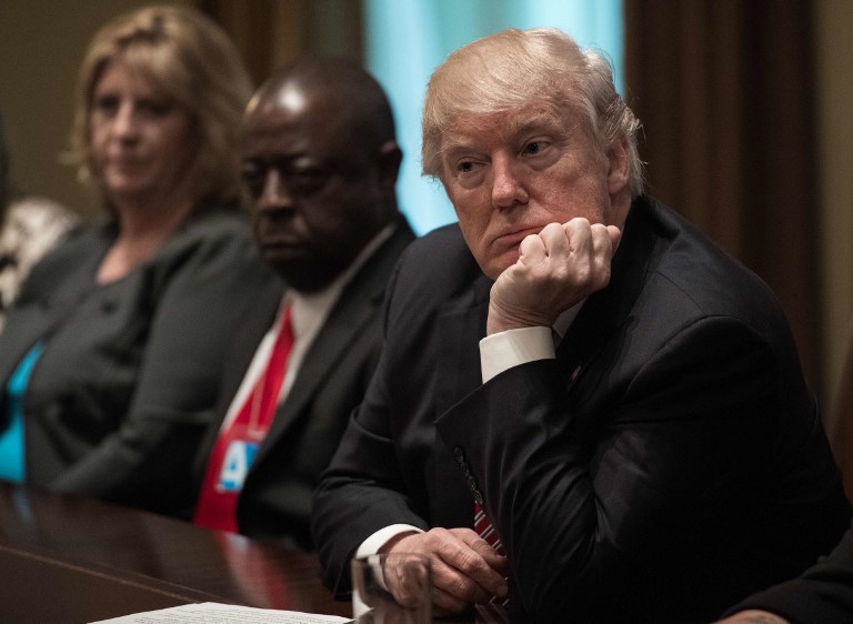 US President Donald Trump listens during a meeting to urge passage of bills to enforce federal laws on immigration in the Cabinet Room at the White House in Washington, DC, on June 28, 2017. / AFP PHOTO / NICHOLAS KAMM