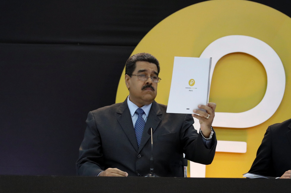 Venezuela's President Nicolas Maduro reads a document during the event launching the new Venezuelan cryptocurrency "Petro" in Caracas